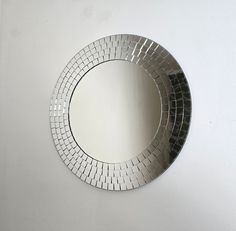 a round mirror hanging on the wall