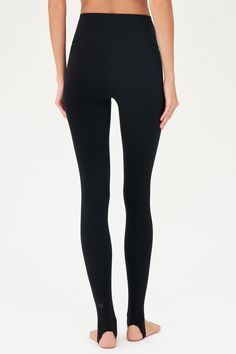 Our famous, form fitting high waist legging redesigned as a stirrup tight. Our ultra luxe Airweight fabric has a supremely soft hand and second skin comfort. BEST FOR: hot yoga, barre, Pilates. Model is 5'10" and wears a size small. Sleek Compression Yoga Bottoms, Sleek Tight Sports Bottoms, Sleek Fitted Training Bottoms, Sleek Tight Bottoms For Yoga, High Rise Tight Leggings For Yoga, Sleek High Stretch Bottoms For Pilates, Tight Elastane Yoga Tights, Sleek Yoga Tights, Yoga Elastane Tights