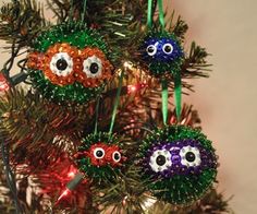 an ornament is hanging on the christmas tree with googly eyes in it