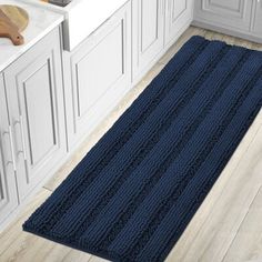 a large blue rug is in the middle of a kitchen