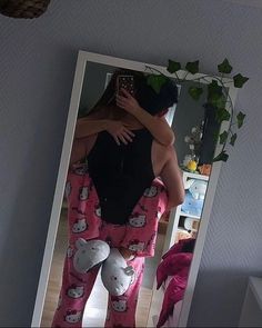 a man in hello kitty pajama pants is hugging a woman's back