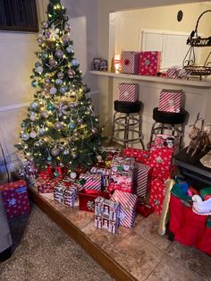 a christmas tree with presents under it