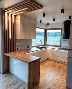 a kitchen with wooden floors and white cabinets