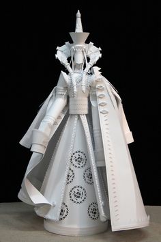 a paper sculpture of a woman in a white dress