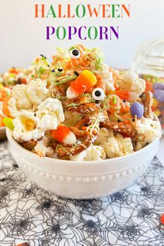 a white bowl filled with halloween popcorn on top of a table