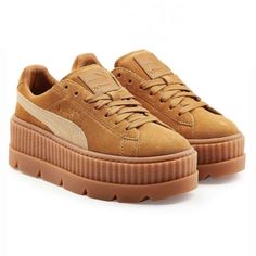 Elevate your shoe game with these stunning FENTY PUMA by Rihanna Cleated Creeper Suede Platform sneakers in golden brown. These stylish sneakers feature a solid pattern with a low top shoe shaft style, lace-up closure, and standard shoe width. The upper material is made up of premium quality suede and the product line is PUMA Platform. The shoes are new with box and are perfect for any athletic activity. The brand is well-known for its quality and comfort, making it a great investment for any sneaker lover. Don't miss out on the chance to add these gorgeous sneakers to your collection. FENTY PUMA by Rihanna Cleated Creeper Suede Platform Golden Brown Size 9.5 New in box and includes Fenty shoe bag Platform Puma Sneakers, Brown Platform Shoes, Shoes Sneakers Brown, Rihanna Shoes, Suede Creepers, Platform Shoes Sneakers, Puma Creepers, Puma Rihanna, Puma Fenty