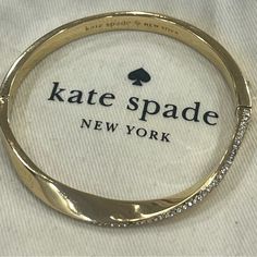 Kate Spade Do The Twist Gold Bangle Bracelet With Hidden Clasp. Pav Round Crystals Twist All Along The Front Of The Bangle. Easy Open Close. Measures 2 1/2” Across In Diameter. New And Never Worn But Tags Have Been Removed And May Have Some Very Light Scratches Just From Being Stored Away Very Minor If Any Just Wanted To Note. Comes With Adorable Kate Spade Mini Dustbag. Buy Today And I Will Always Ship Same Day/Next Morning! Always Open To Reasonable Offers! Kate Spade Elegant Bangle Jewelry, Kate Spade Gold Bracelets, Chic Adjustable Kate Spade Jewelry, Kate Spade Bangle Bracelet For Weddings, Kate Spade Bangle Bracelets For Wedding, Chic Gold Kate Spade Bracelets, Chic Kate Spade Bangle Bracelet, Chic Kate Spade Gold Bracelets, Bracelet Cuff