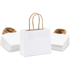 white paper bags with rope handles and handles on each side, stacked up against one another