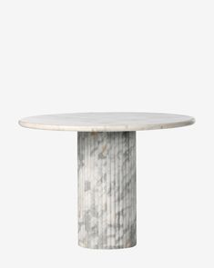 a white marble table with an oval base