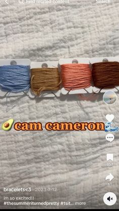 three spools of thread sitting on top of a white sheet with the words cancan