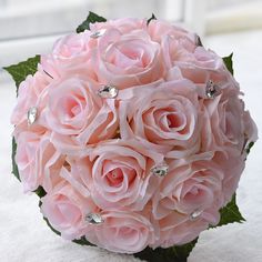 a bouquet of pink roses sitting on top of a table