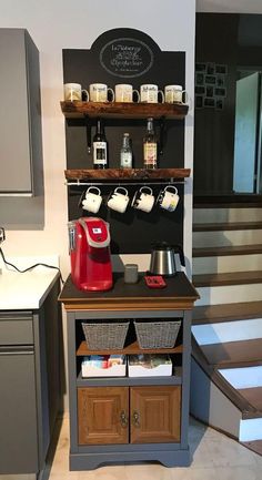 a small coffee shop with stairs leading up to the second floor and an espresso machine