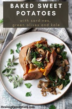 baked sweet potatoes with sardines, green olives and kale on a plate