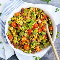 a white bowl filled with vegetables on top of a wooden table