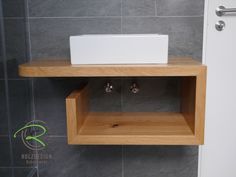 a wooden shelf with a sink on top of it