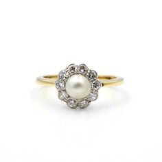 an antique pearl and diamond cluster ring in 18ct yellow gold, set with white diamonds