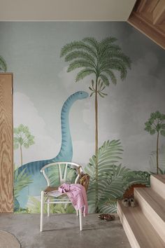 a child's room with a dinosaur wall mural and stairs leading up to the second floor