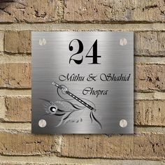 a metal sign on the side of a brick wall that says, 24 within & shahad shopa