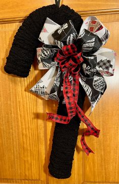 a door hanger with a black and red bow