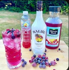 three different types of drinks sitting on top of a wooden table next to each other