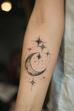 a person with a tattoo on their arm that has a crescent and stars in it