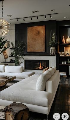 a living room filled with furniture and a fire place under a painting on the wall