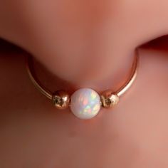 a close up view of a nose with an opal in the middle