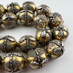 One handmade Kazakh style turkoman silver bead on brass. No two are exactly alike - hand fabricated. Lightweight gorgeous bead made in a very old tradition for an ethnic tribal look. So lightweight, we love the bigger bold look without the heavy weight.  One bead 25x19 approximately 3.5mm hole. Artisan Handmade Beads For Festive Occasions, Artisan Handmade Festive Beads, Silver Beads For Festivals, Artisan Necklace With Oxidized Finish And Round Beads, Artisan Brass Jewelry With Round Beads, Bohemian Jewelry With Oxidized Round Beads, Traditional Handmade Beads For Festive Occasions, Handmade Traditional Beads For Festive Occasions, Traditional Handmade Ceremonial Beads