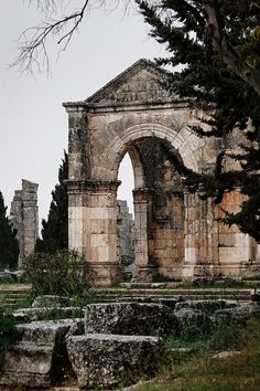 an old stone building surrounded by trees and rocks