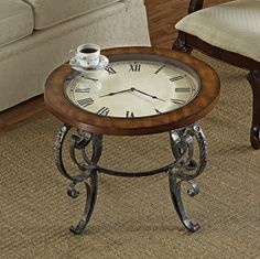 a coffee table with a clock on it in the middle of a room next to a couch