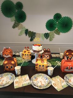 an animal themed birthday party with plates, cups and napkins