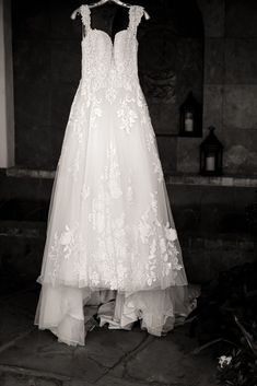 a wedding dress hanging on a hanger