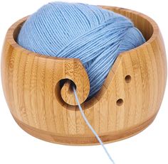 a ball of yarn in a wooden holder