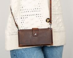 a woman holding a brown leather purse