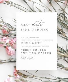 a white wedding card with pink flowers on it