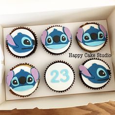 the cupcakes are decorated with blue and pink fondant characters, which have numbers on them