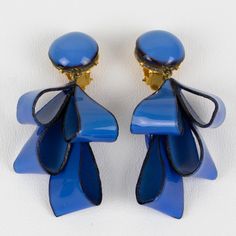 Lovely dimensional dangling clip-on earrings designed by Cilea Paris. These hand-made artisanal resin earrings feature dimensional ribbons with textured patterns built together to form a powerful statement piece. Very nice cobalt blue with a black contrast color. Marking underside of each earring: Cilea - Paris. Measurements: 1.57 in wide (3.9 cm) x 2.82 in high (7.2 cm).  Please see the measurements noted above in the description for the best approximate dimensions. Blue Clip-on Drop Earrings, Blue Clip-on Earrings As Gift, Blue Clip-on Earrings For Evening, Blue Drop Clip-on Earrings For Evening, Resin Earrings, Clip Earrings, Blue Ribbon, Color Collection, Designer Earrings