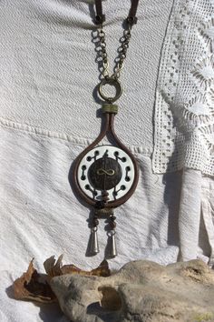 This handmade necklace tells a story about people and time.Is a tear or a drop with a clock without needles in the center-just the infinite. It can be worn on different outfits and adds originality, style and a bohemian air. It is unique and made of wood,metal,leather. Can be a wonderful gift for a dear person who deserves and appreciates the special things and why not the starting point of some some discussions or stories. Handmade Teardrop Necklaces For Festivals, Handmade Teardrop Necklace For Festivals, Unique Teardrop Necklace For Festival, Unique Teardrop Necklace For Festivals, Handmade Adjustable Medallion Necklace, Handmade Adjustable Teardrop Pendant Necklace, Handmade Adjustable Teardrop Drop Necklace, Unique Nickel Free Brown Necklaces, Handmade White Necklace For Everyday