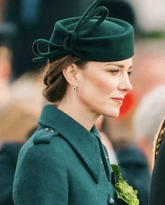 a woman wearing a green coat and hat