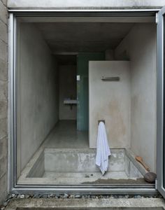 an open door leading to a bathroom with a white towel hanging from the side of it