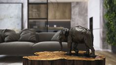 a statue of an elephant standing on top of a wooden table in a living room