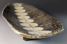 a brown and white plate sitting on top of a table