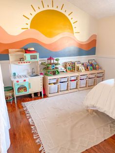 a child's playroom with toys on the floor and wall painted in pastel colors