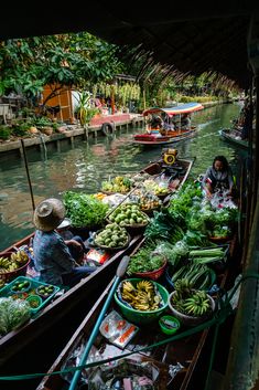 two boats filled with lots of fresh produce