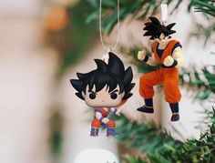 an ornament hanging from a christmas tree with gohan and vegeta