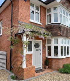 a brick house with white trim and windows