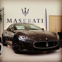 a maserati car is on display in a showroom