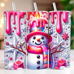 three frosted candles with snowman and penguin on them, one has a candle in the shape of a melting snowman