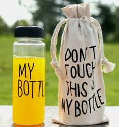 two bottles are sitting next to each other on a table with the words, don't touch this is my bottle