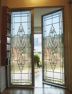 an open glass door with a bookcase in the background